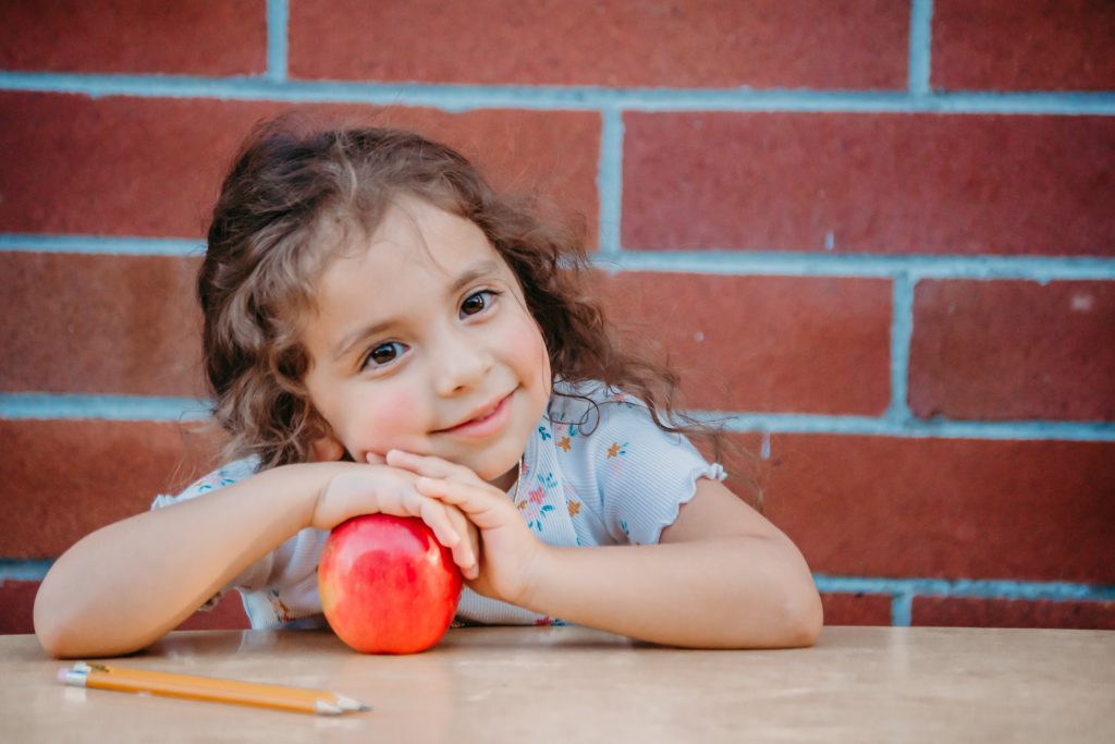 cute schoolgirl with apple